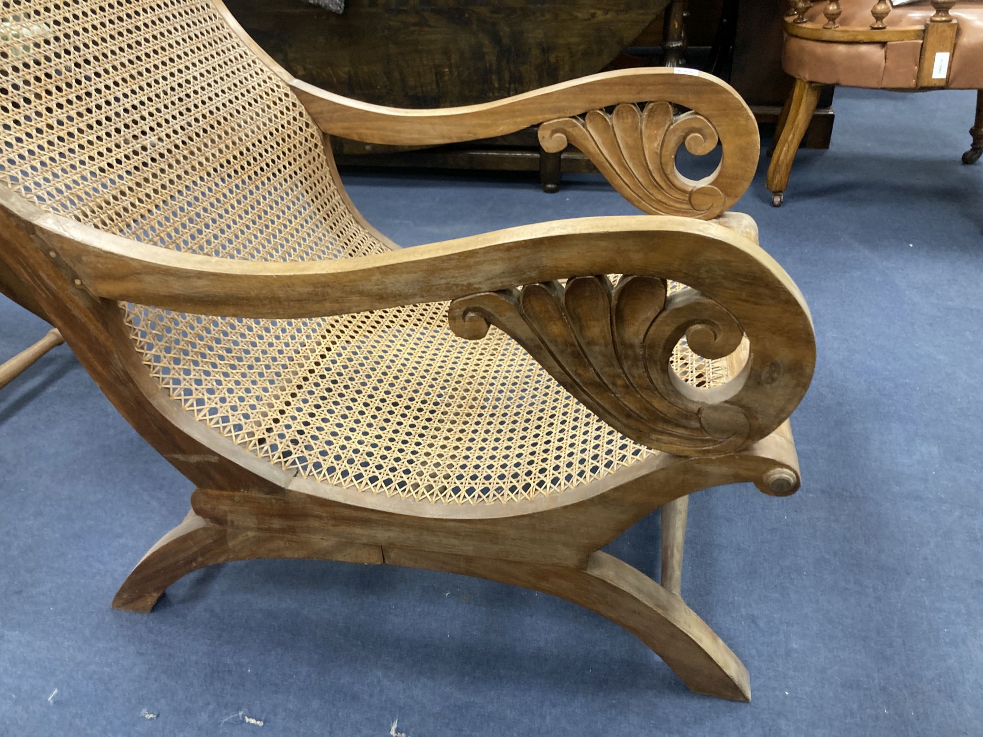 An early 20th century Anglo-Indian caned weathered teak armchair, width 57cm, depth 90cm, height 85cm